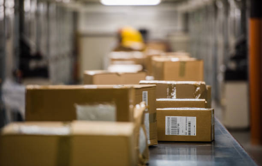 Boxes with shipping labels on conveyor belt