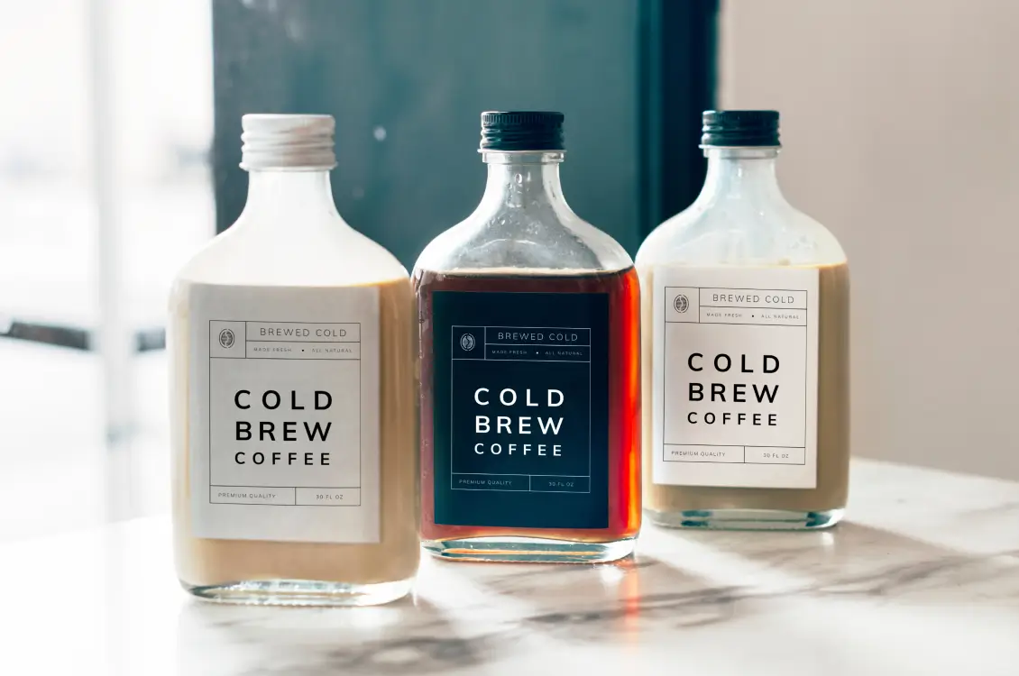 Labeled cold brew coffee on a marble countertop.