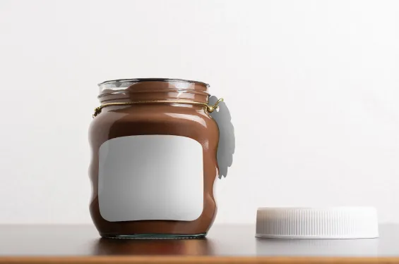 Glass jar with chocolate spread and blank label