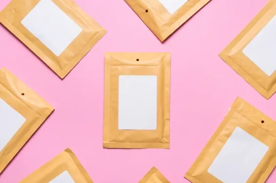 Labeled envelopes arranged on a pink background for business use.
